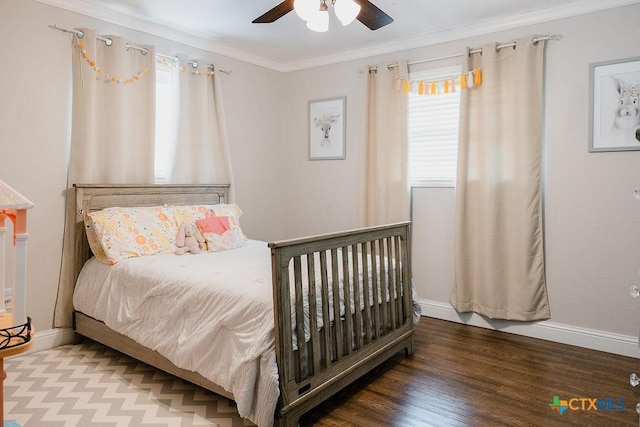 bedroom with baseboards, crown molding, a ceiling fan, and wood finished floors
