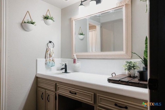 full bathroom featuring vanity and tasteful backsplash