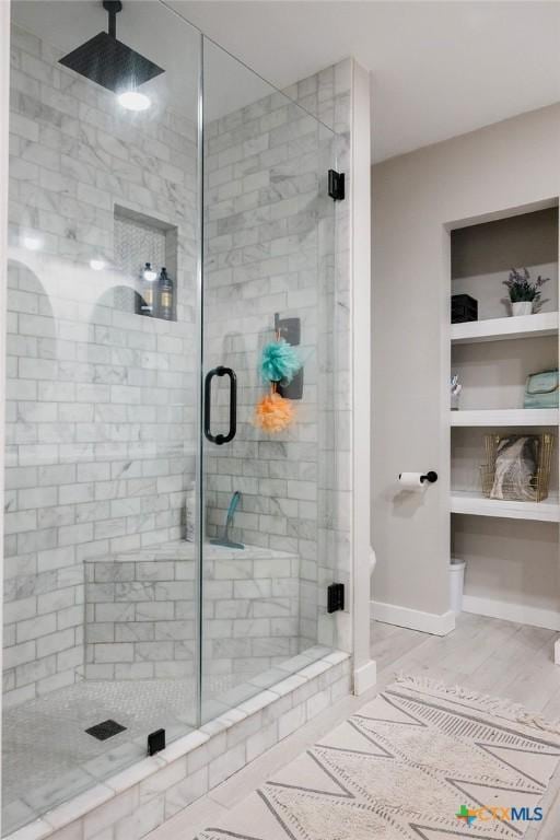 full bathroom with baseboards and a shower stall