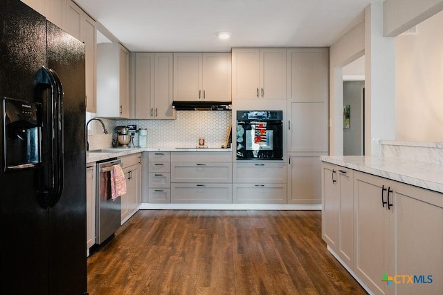 kitchen with a sink, gray cabinetry, light countertops, and black appliances