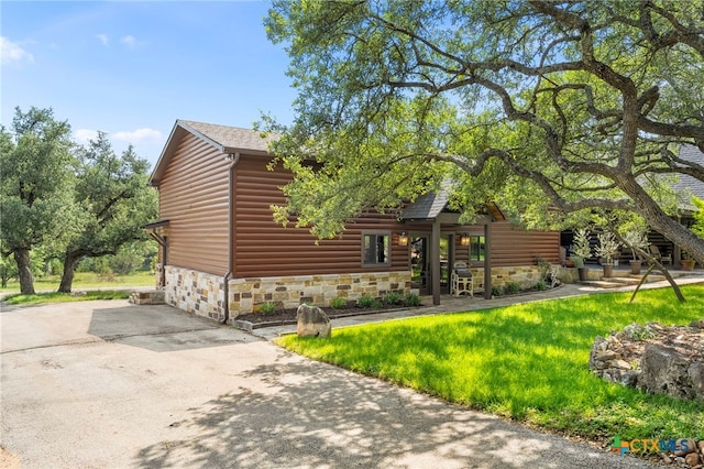 332 Westin Hls, New Braunfels, TX 78132 - view of front facade featuring stone siding, faux log siding, and a front yard