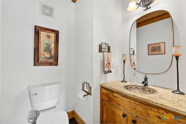 bathroom with toilet and vanity