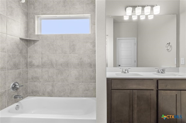 bathroom with vanity and tiled shower / bath combo