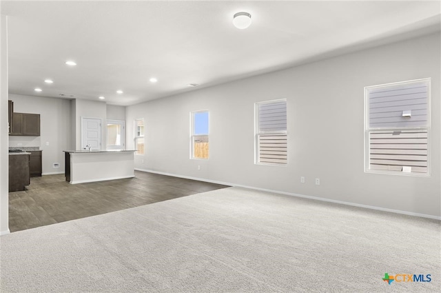 unfurnished living room featuring dark wood-type flooring