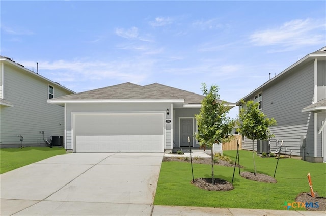 ranch-style house with a garage, a front lawn, and central air condition unit