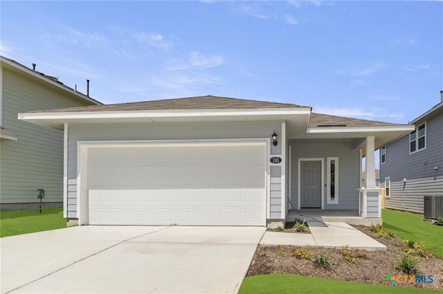 ranch-style home with cooling unit and a garage