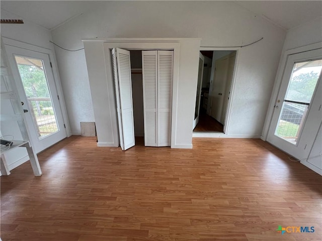 184 Guadalupe Hills Ln, Seguin, TX 78155 - unfurnished bedroom featuring vaulted ceiling, access to exterior, light wood finished floors, and multiple windows
