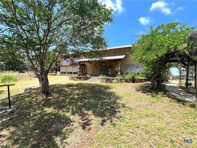 184 Guadalupe Hills Ln, Seguin, TX 78155 - back of property with a lawn and a metal roof