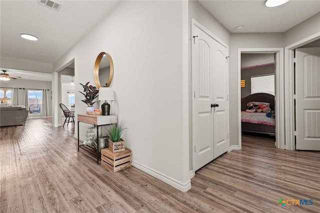 hallway with wood-type flooring