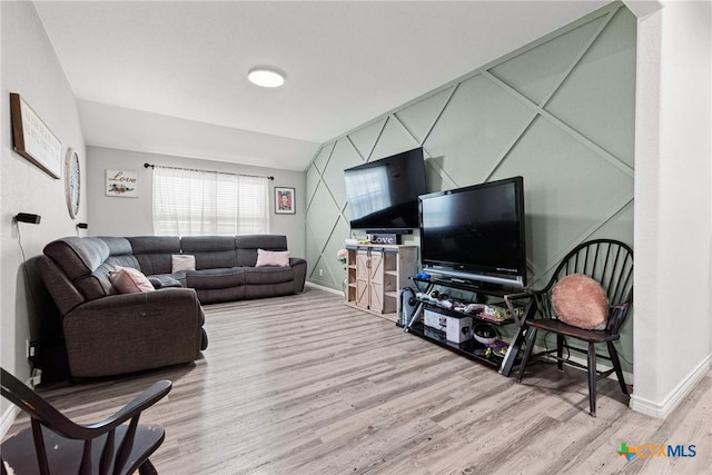 living room with lofted ceiling and light wood-type flooring