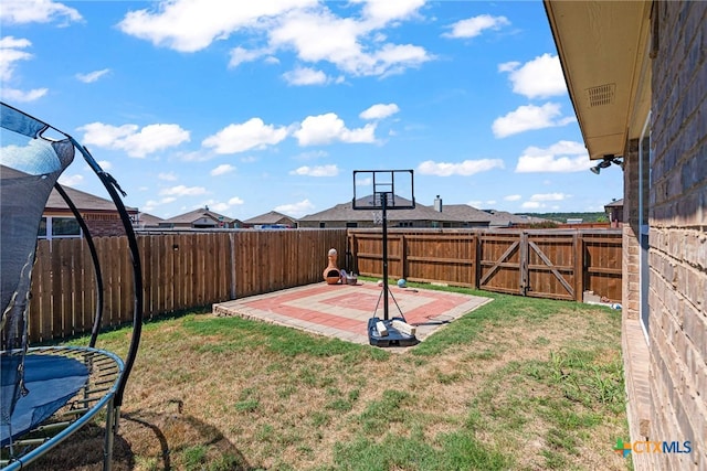 view of yard featuring a patio and a trampoline