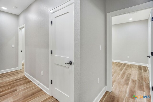 corridor featuring light hardwood / wood-style flooring