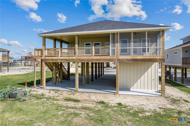 back of house with a sunroom and a carport