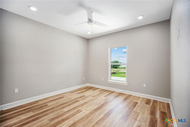 spare room featuring ceiling fan and light hardwood / wood-style flooring