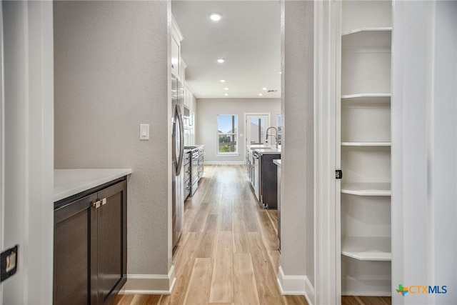 corridor with light hardwood / wood-style flooring