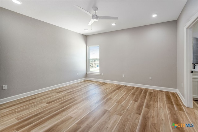 empty room featuring ceiling fan and light hardwood / wood-style flooring