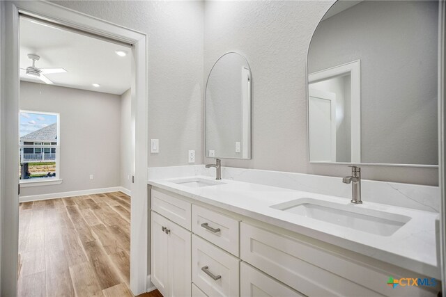 bathroom featuring vanity, hardwood / wood-style floors, and ceiling fan