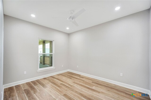 spare room featuring light wood-type flooring and ceiling fan