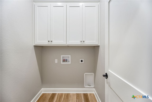 laundry room with hookup for an electric dryer, light hardwood / wood-style flooring, cabinets, and hookup for a washing machine