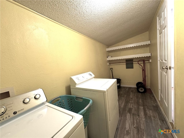 laundry room with washing machine and dryer, dark hardwood / wood-style floors, and a textured ceiling