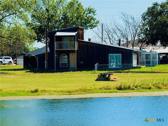 rear view of property featuring a lawn