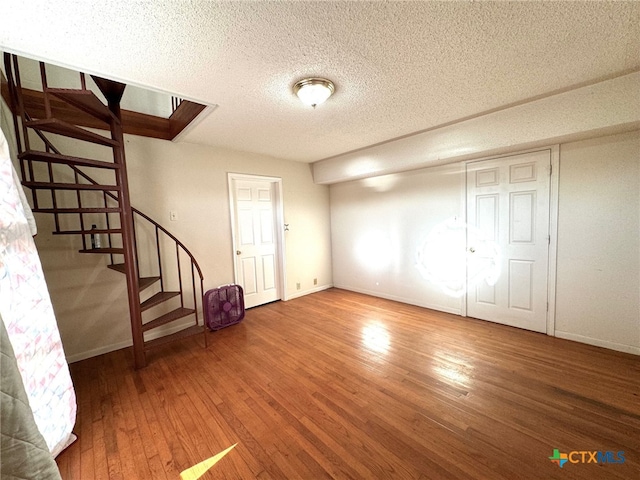 interior space with wood-type flooring and a textured ceiling