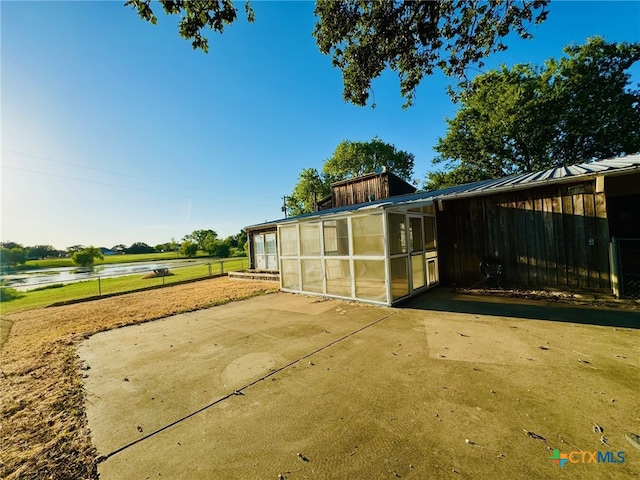 exterior space featuring an outbuilding and a water view