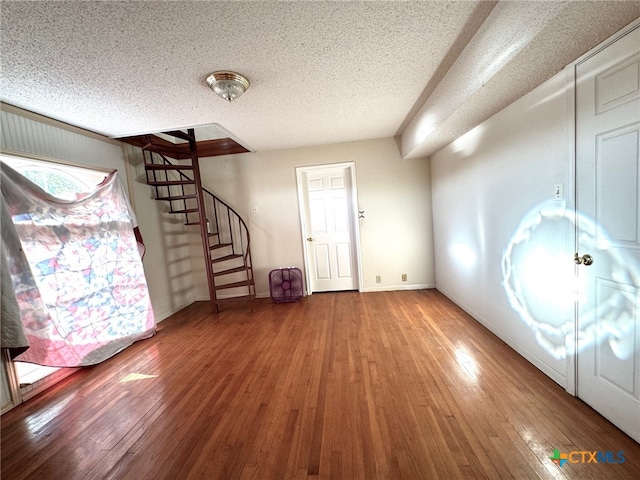 foyer featuring wood-type flooring and a textured ceiling