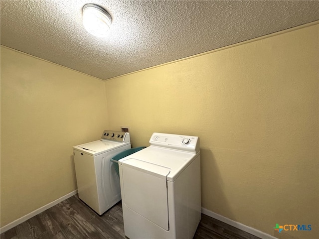 clothes washing area featuring dark hardwood / wood-style floors, a textured ceiling, and independent washer and dryer