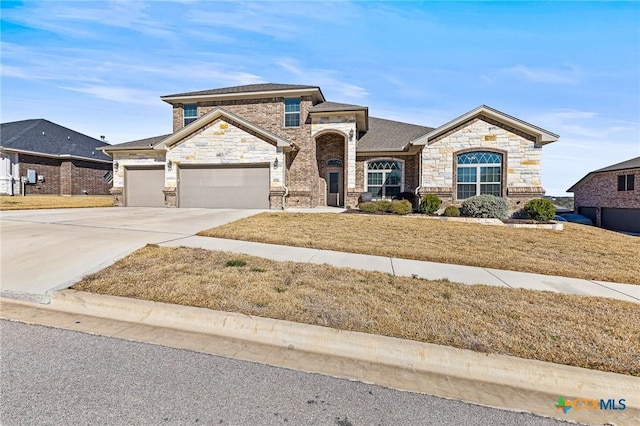 view of front of house with driveway, an attached garage, a front yard, and brick siding