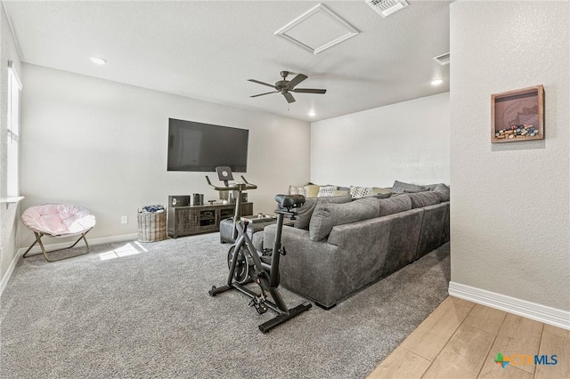 living room featuring wood finished floors, visible vents, and baseboards