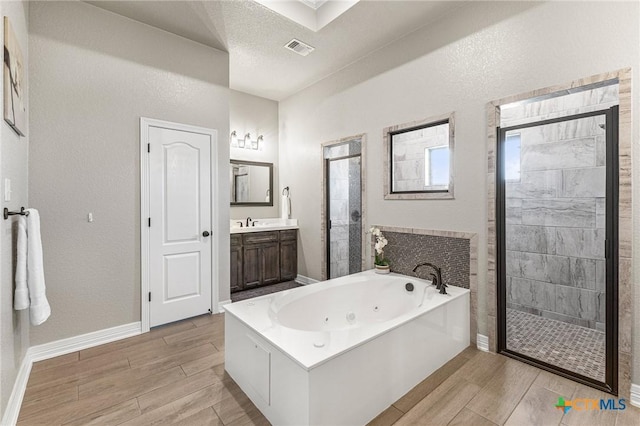 bathroom with wood finish floors, visible vents, and a shower stall