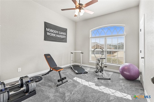 exercise room with carpet floors, ceiling fan, and baseboards
