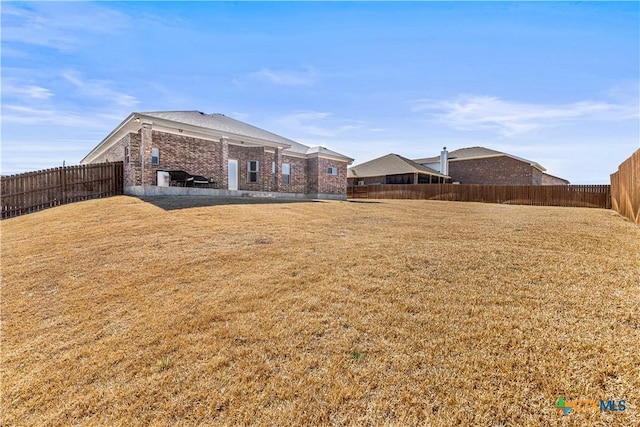 view of yard with a fenced backyard