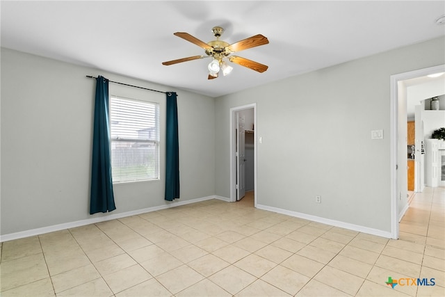 unfurnished room with light tile patterned floors and ceiling fan