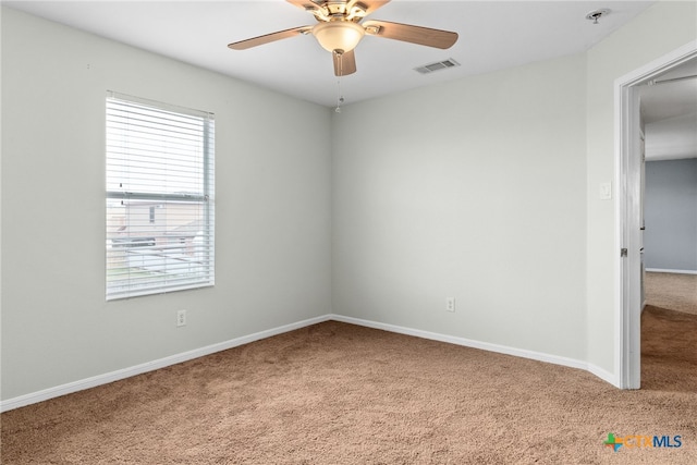 unfurnished room with carpet flooring and ceiling fan