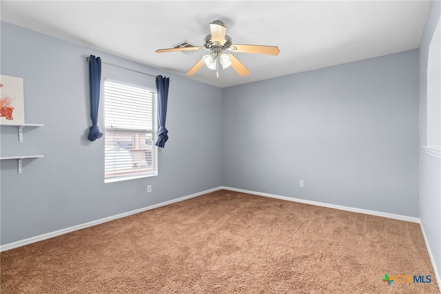 carpeted empty room featuring ceiling fan