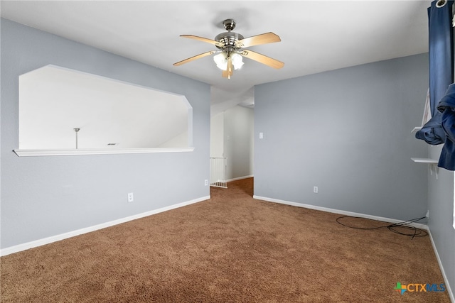 carpeted spare room featuring ceiling fan