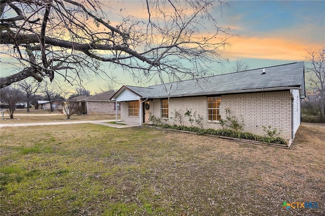 ranch-style home featuring a yard