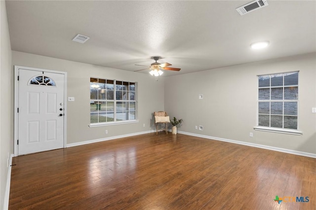 entryway with dark hardwood / wood-style floors and ceiling fan