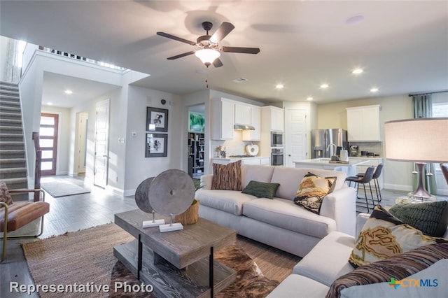 164 Linnet Ln, Maxwell, TX 78656 - living room with stairs, healthy amount of natural light, wood finished floors, ceiling fan, and recessed lighting