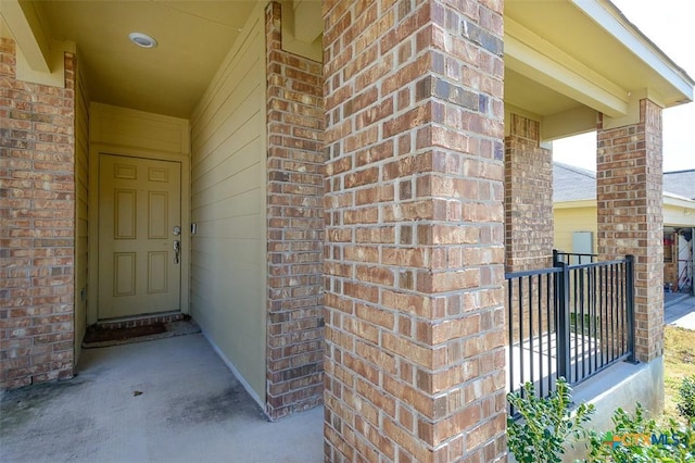 entrance to property with brick siding