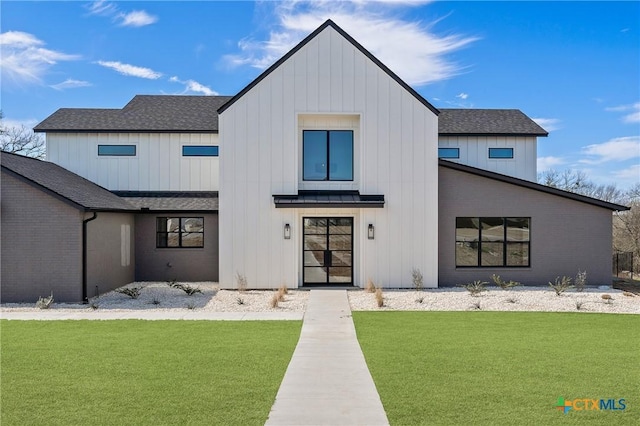 modern inspired farmhouse featuring board and batten siding, a front yard, and roof with shingles