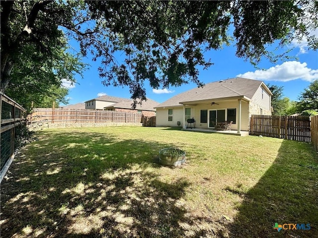 4208 Brookhaven Dr, Temple, TX 76504 - fenced backyard featuring a ceiling fan and a patio area