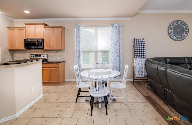 4208 Brookhaven Dr, Temple, TX 76504 - kitchen featuring dark countertops, crown molding, stainless steel range with electric cooktop, backsplash, and open floor plan