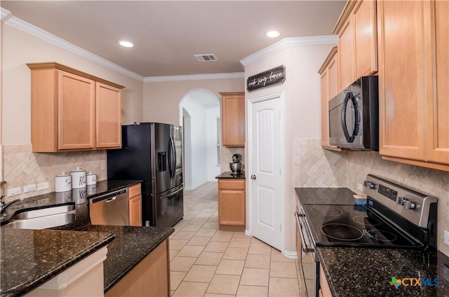 4208 Brookhaven Dr, Temple, TX 76504 - kitchen with appliances with stainless steel finishes, light brown cabinets, arched walkways, light tile patterned floors, and crown molding