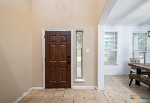 4208 Brookhaven Dr, Temple, TX 76504 - entryway with arched walkways, light tile patterned flooring, and crown molding