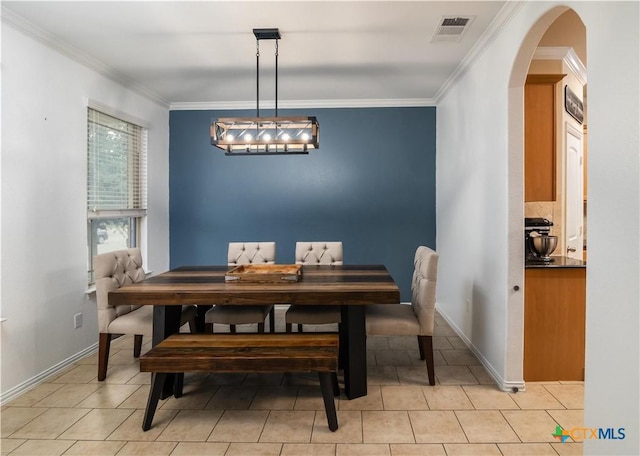 4208 Brookhaven Dr, Temple, TX 76504 - dining space with arched walkways, crown molding, and light tile patterned flooring