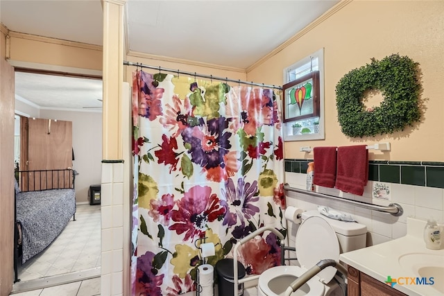 bathroom featuring a shower with curtain, vanity, crown molding, toilet, and tile walls