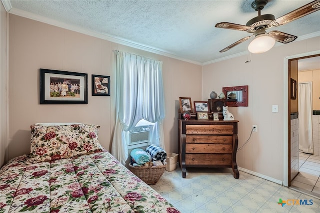 bedroom featuring ornamental molding, cooling unit, a textured ceiling, and ceiling fan